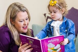 Girl reading with a speech pathologist