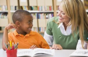 Boy reading with a speech pathologist